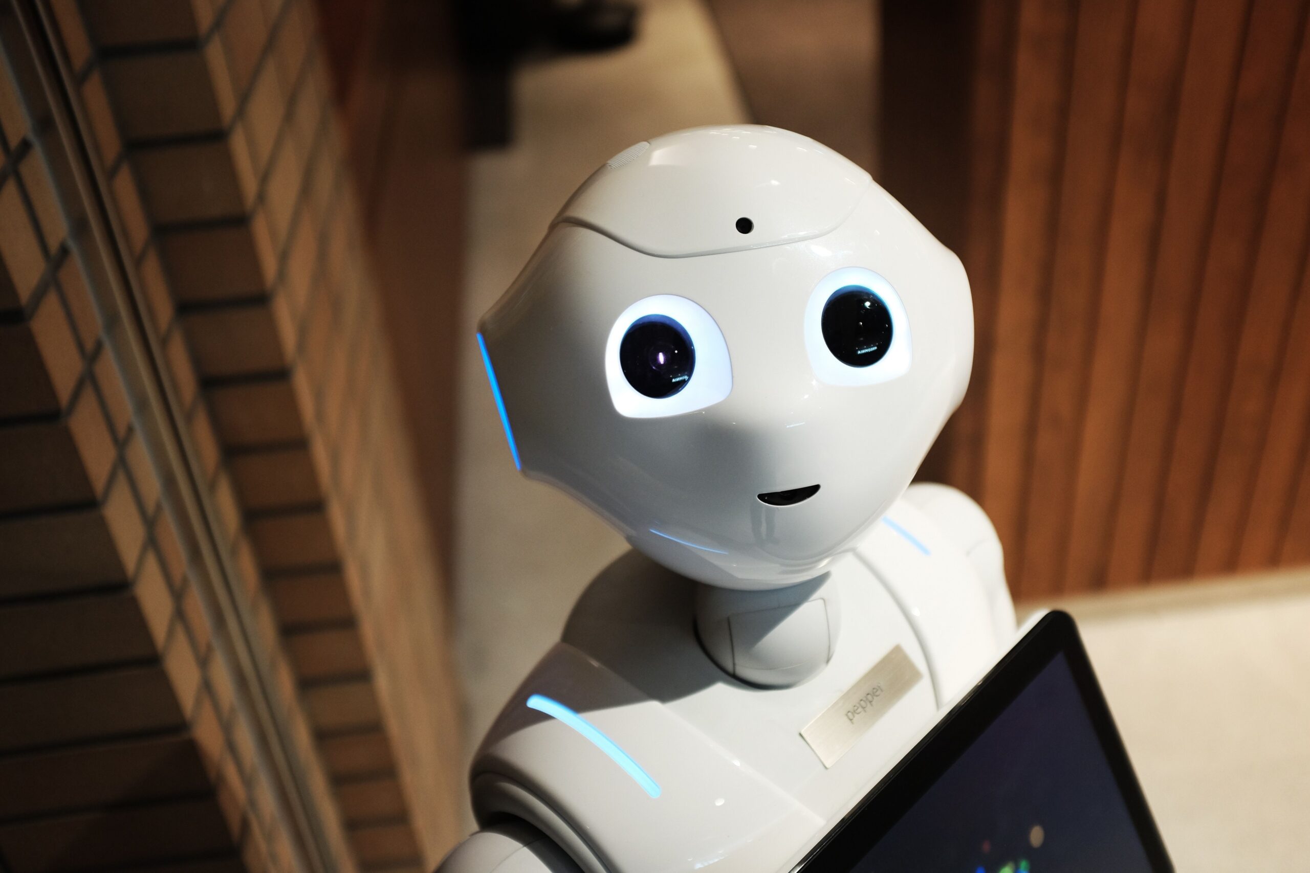 Cute robot holding a screen to represent AI marketing